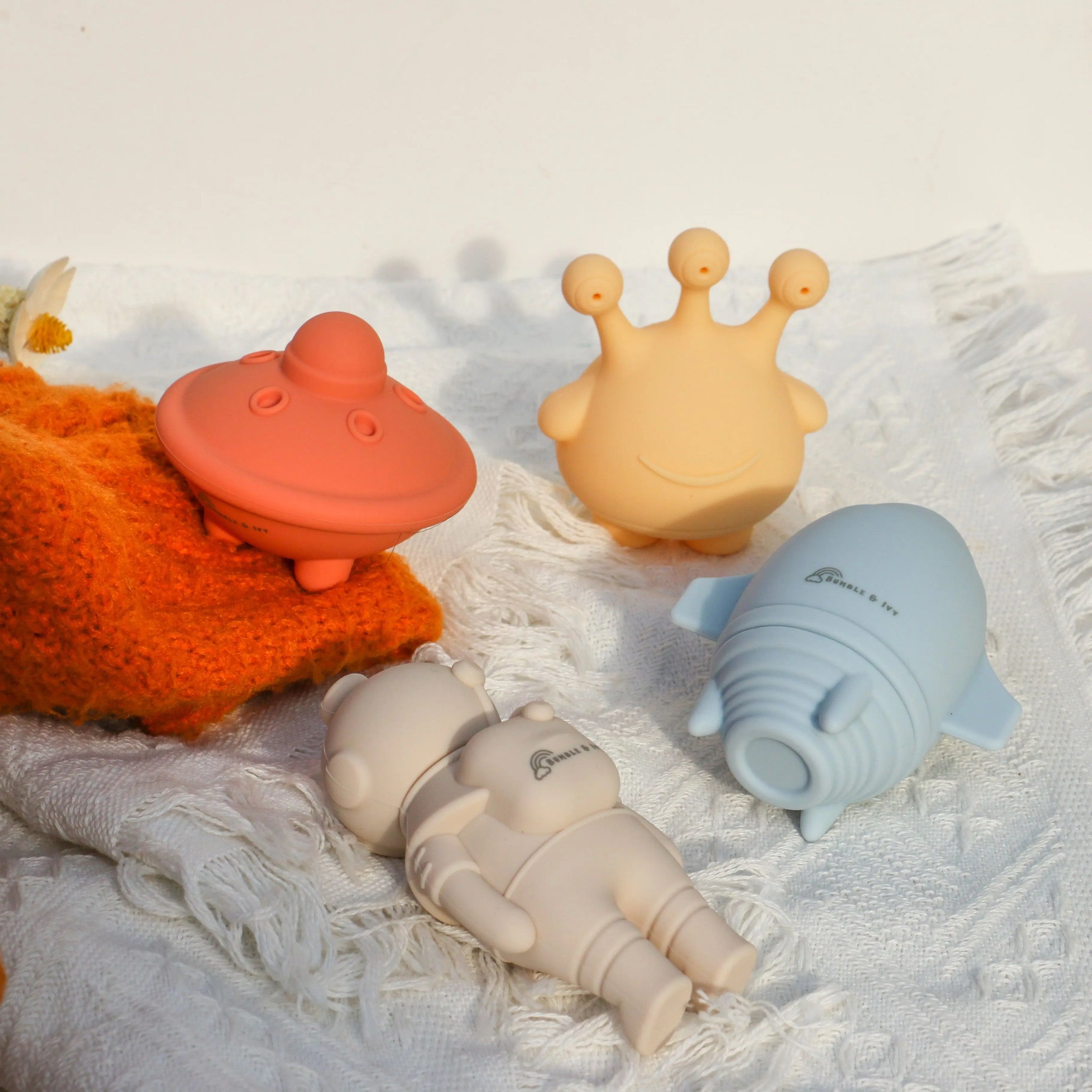 Bumble & Ivy mould free bath toys in a space theme, featuring a safe silicone rocket, UFO, alien, and astronaut designed to twist open for complete drying.
