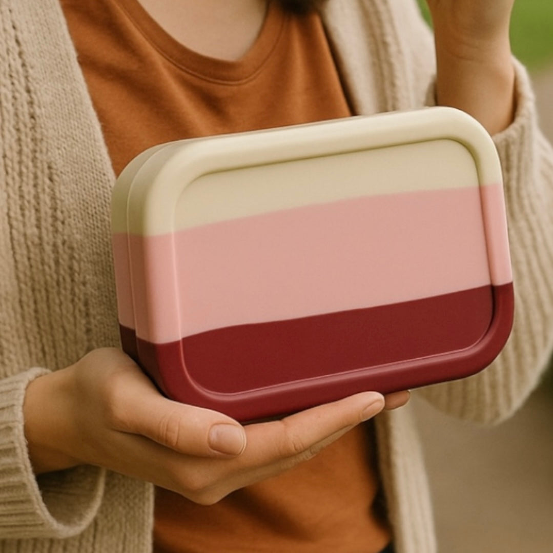 Bumble & Ivy Berry Blush 3 compartment silicone bento box held in hands, reusable lunch box for kids school lunches, toddler meals and healthy snacks