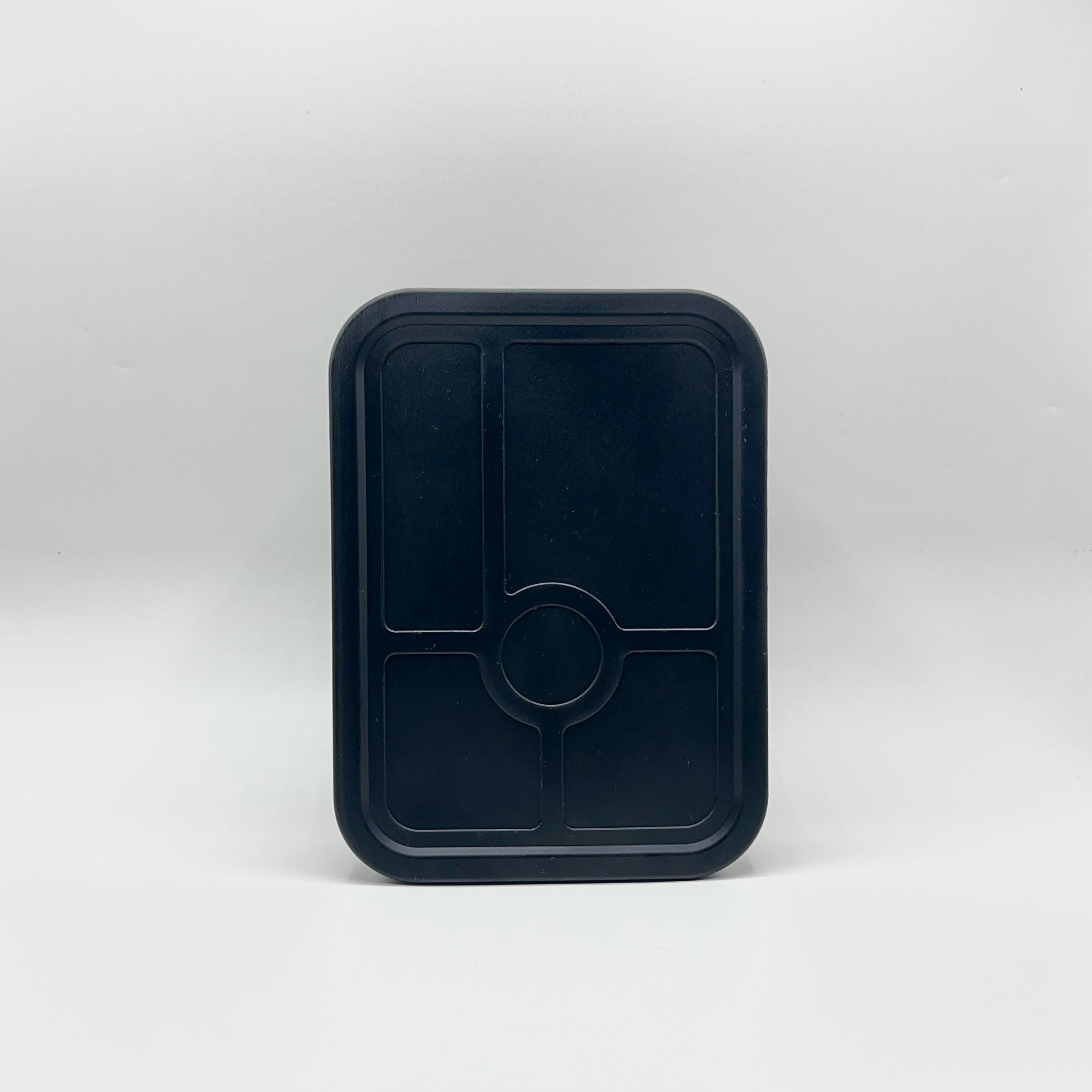 Top-down view of the closed Bumble & Ivy midnight black silicone bento box with its leakproof lid securely attached, on a plain white background.