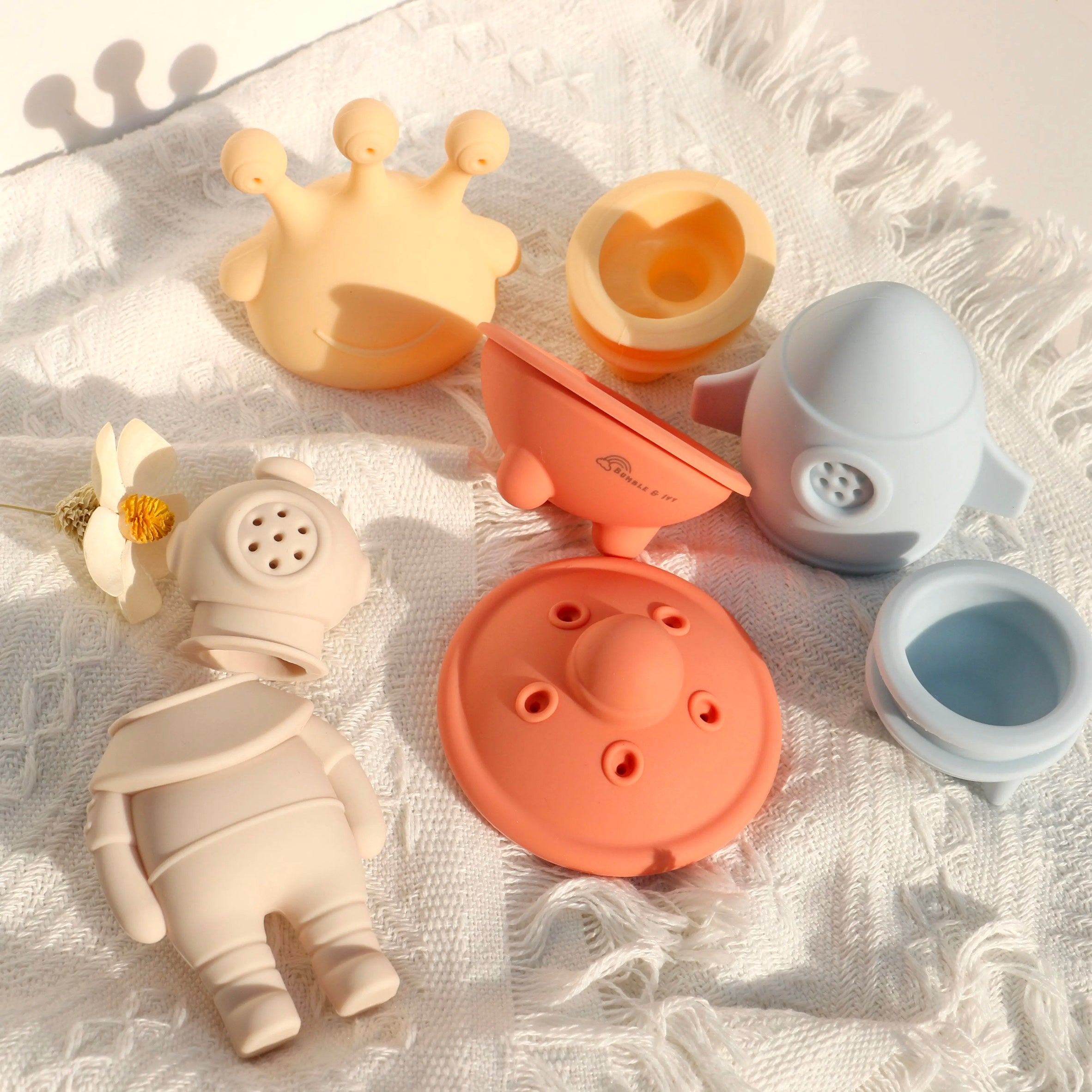 Mould-free silicone bath toys opened in half to show the easy-clean interior, preventing hidden mould build-up.