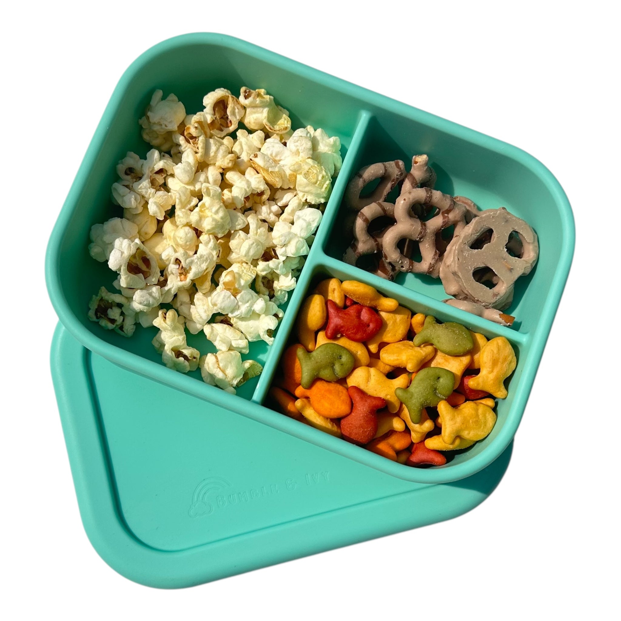 Bumble & Ivy Pearl Aqua 3-compartment silicone kids bento box filled with healthy school snacks.