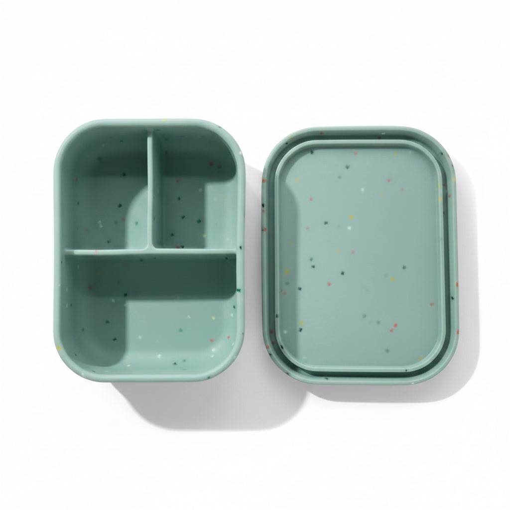 Bumble & Ivy Speckled Sage 3 compartment silicone bento lunch box with lid removed, showing leak-resistant compartments. BPA-free reusable lunch box for toddlers, children, nursery and school lunches.