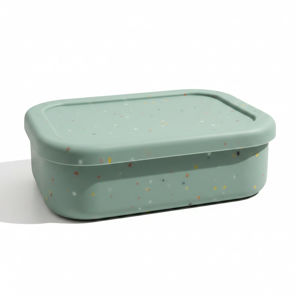 Bumble & Ivy Speckled Sage silicone bento lunch box with lid closed. Reusable BPA-free lunch container in soft sage green with speckled finish, ideal for toddlers, nursery, school lunches and family days out.