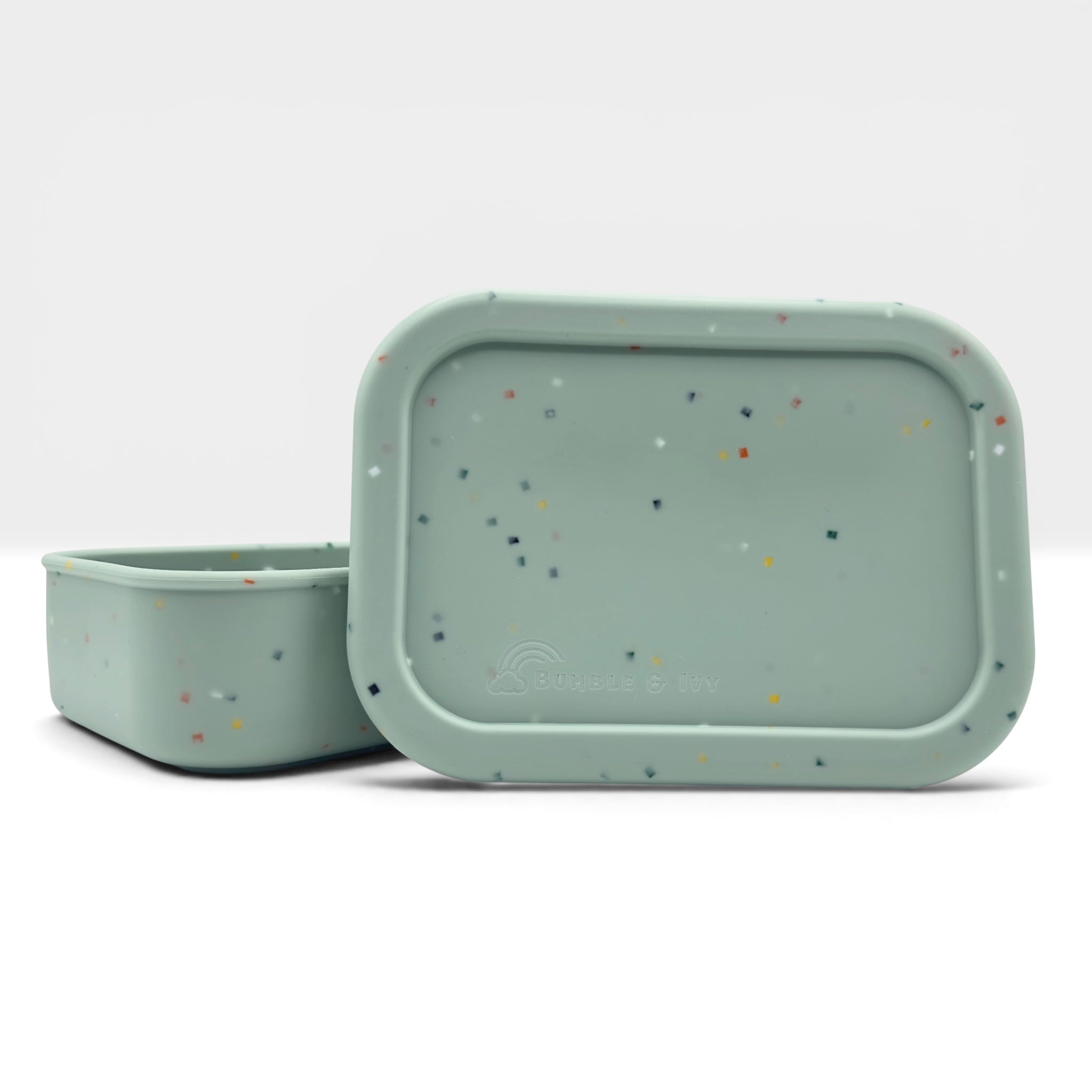 Bumble & Ivy Speckled Sage silicone bento lunch box with fitted lid in soft sage green and speckled finish. Reusable BPA-free lunch container for toddlers, nursery, school lunches and family outings.