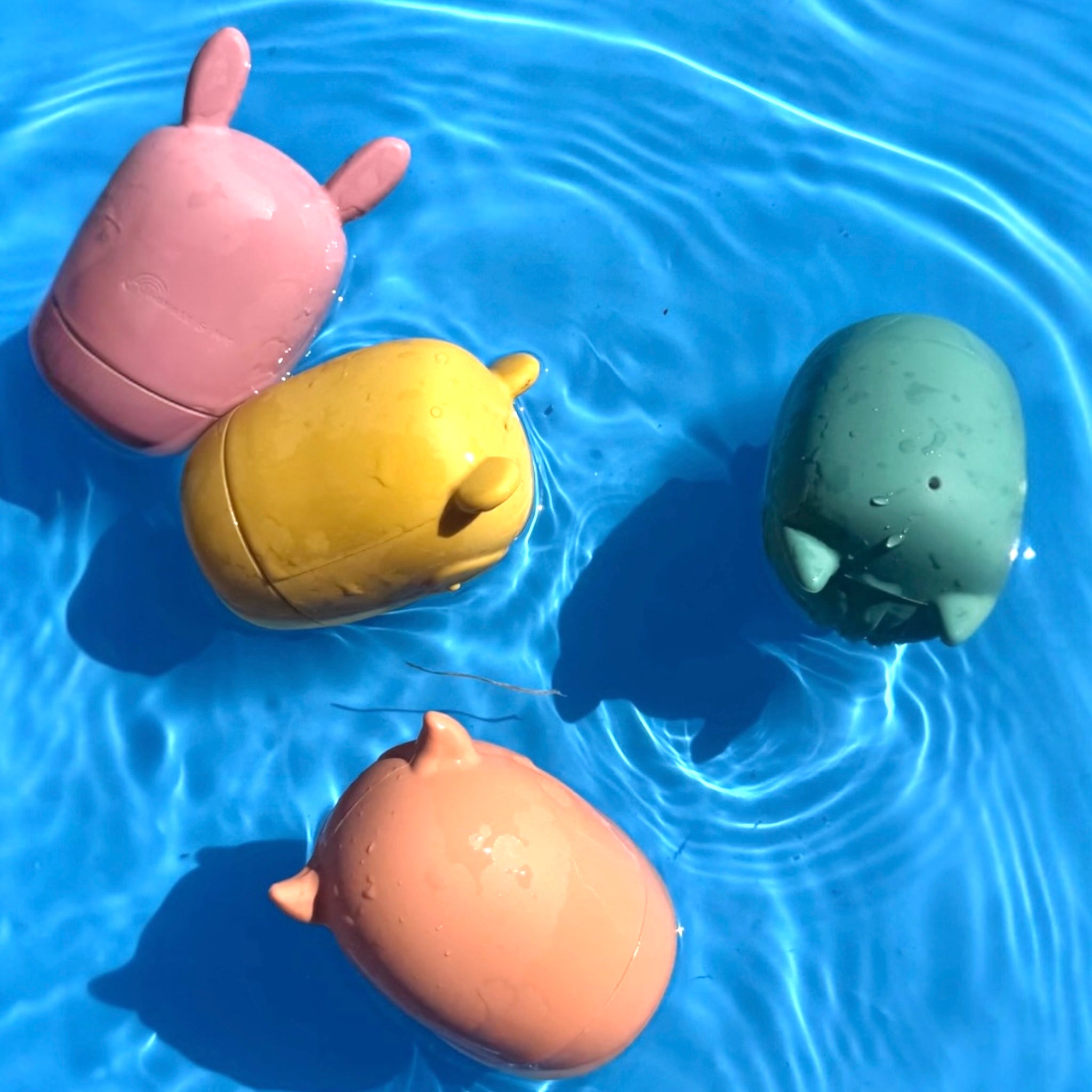 Bumble & Ivy Woodland Bath Toys floating in water. Easy-clean mould-resistant silicone bath toys featuring bear, owl, fox and bunny characters designed for sensory play, water play and toddler bath time fun.